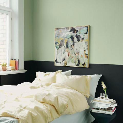 A bedroom with half of the wall painted with Benjamin Moore's HC-120 Van Alen Green, a paint color available at Cincinnati Color Company in Ohio.